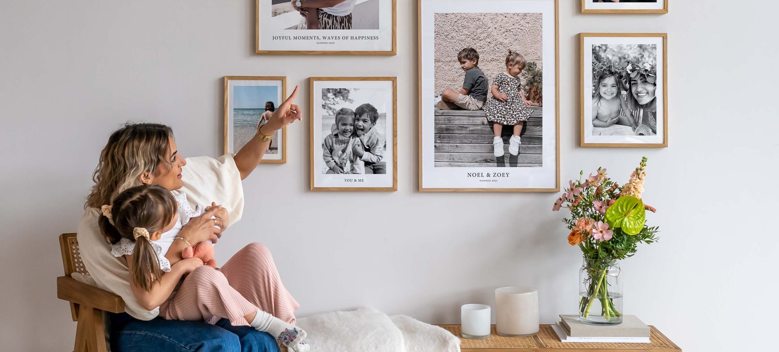 Mother showing her daughter a gallery wall