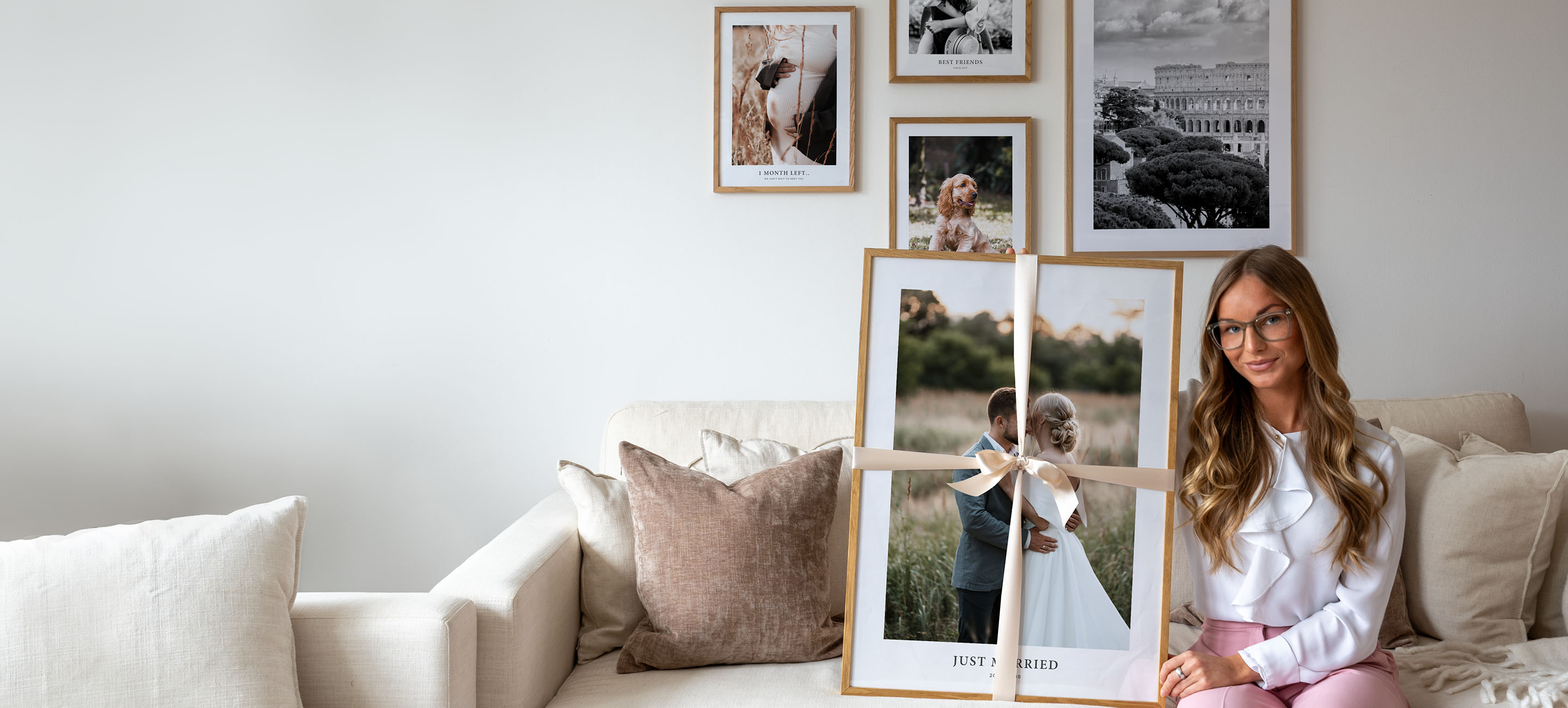 Valentines day gallery wall with young woman holding a frame with a ribbon