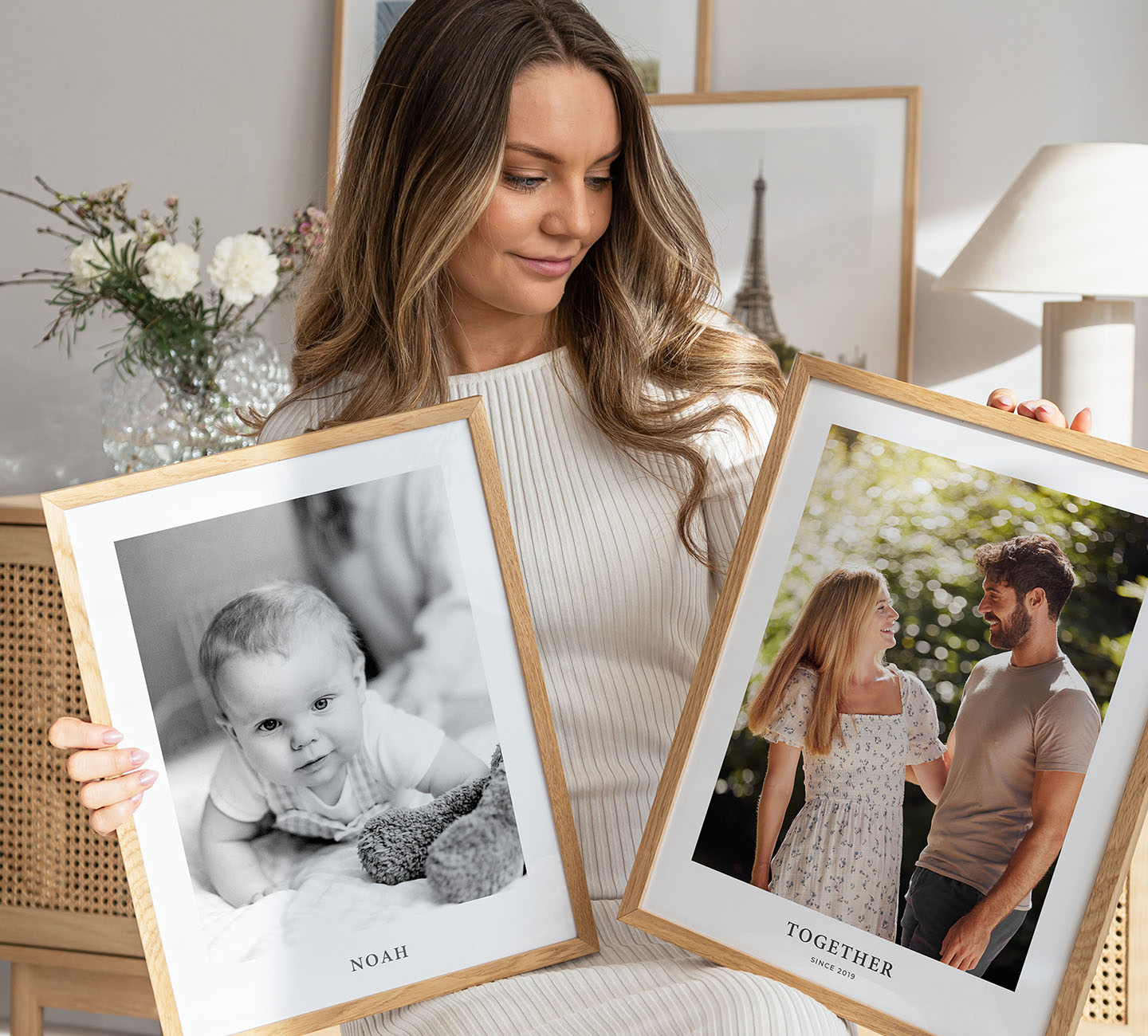 Woman holding two photo posters
