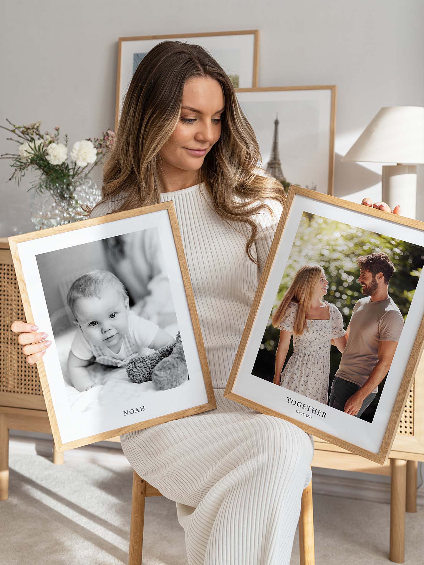 Woman holding two photo posters