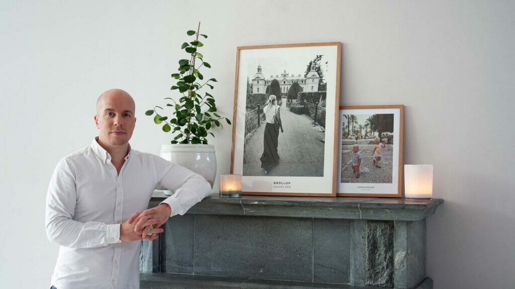 Wallpoet founder Erik Planander standing next to two Wallpoet posters of his wife and two sons