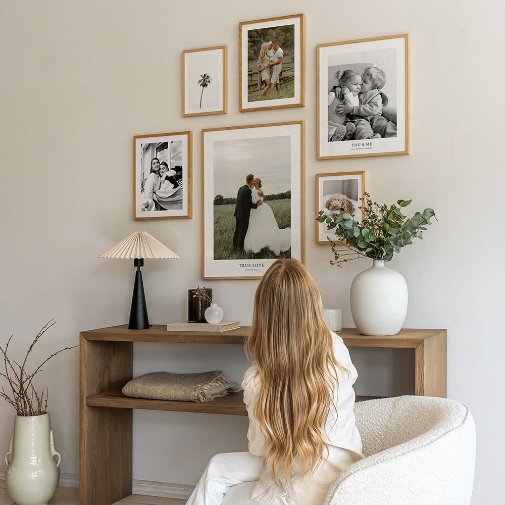 Woman looking at final gallery wall