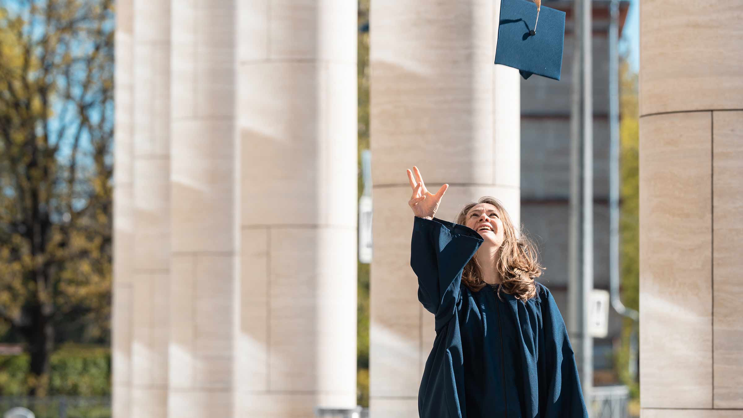 Woman throwing her graduation hat in the air